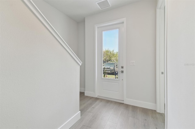 4717 W Mccoy St Unit 2, Tampa, FL 33616 - doorway to outside featuring light wood finished floors and baseboards