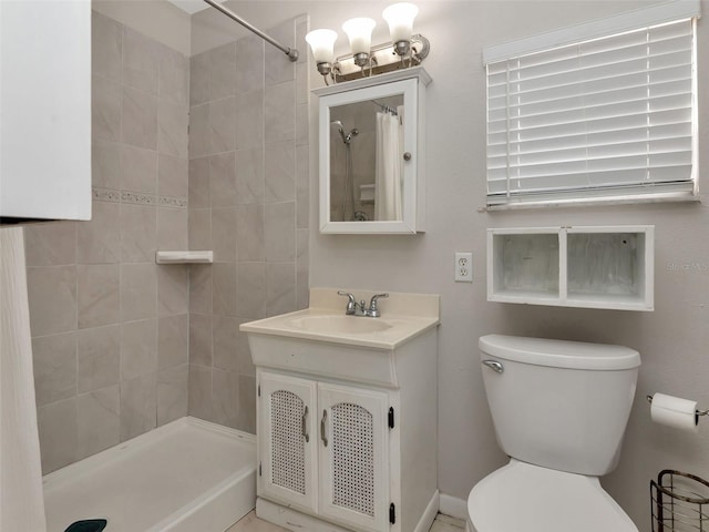full bathroom featuring vanity, toilet, and tiled shower