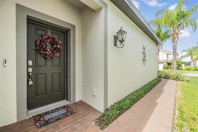 property entrance with stucco siding