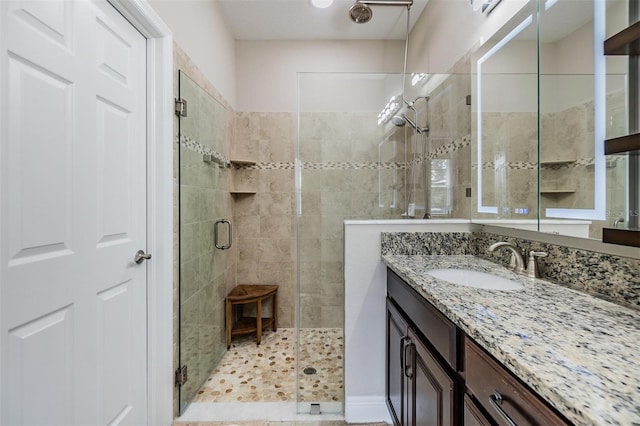 bathroom featuring vanity and a shower stall