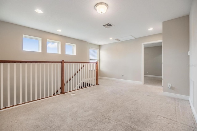 carpeted spare room with visible vents, recessed lighting, and baseboards
