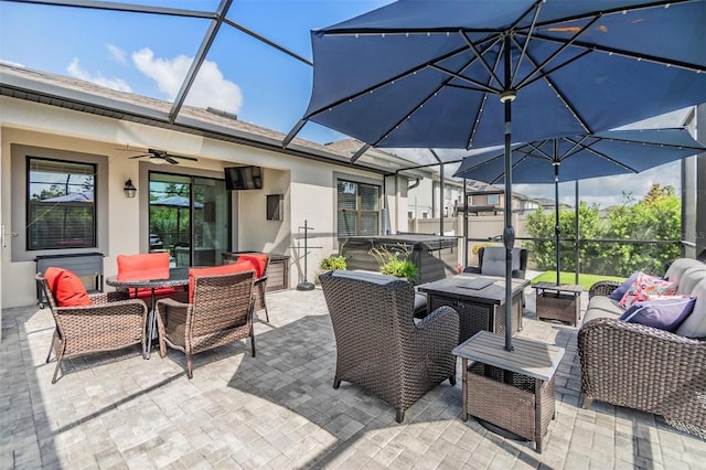 view of patio / terrace featuring an outdoor living space, a ceiling fan, a hot tub, a lanai, and outdoor dining space