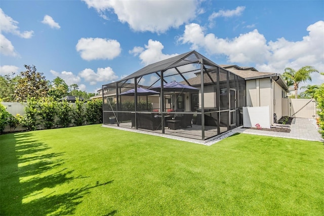 back of house featuring a jacuzzi, a fenced backyard, a patio area, a lanai, and a yard