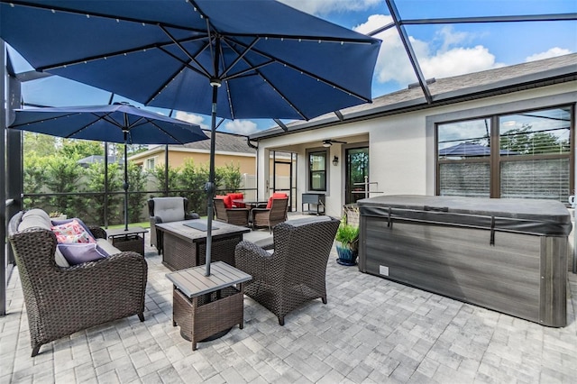 view of patio with a hot tub, ceiling fan, a lanai, and an outdoor hangout area