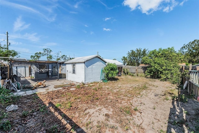 view of yard with a fenced backyard, a patio area, and an outbuilding