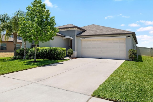 5208 Dandelion St, Apollo Beach, FL 33572 - view of front facade with a garage, driveway, a front yard, and stucco siding