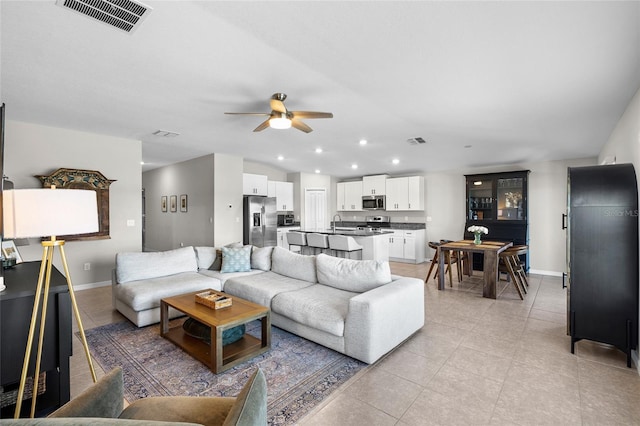 5208 Dandelion St, Apollo Beach, FL 33572 - living area with a ceiling fan, baseboards, visible vents, and light tile patterned floors