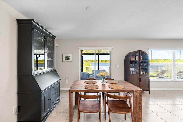 5208 Dandelion St, Apollo Beach, FL 33572 - dining room featuring light tile patterned flooring and baseboards