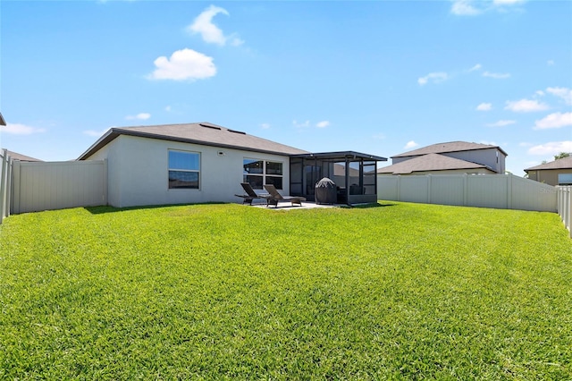 5208 Dandelion St, Apollo Beach, FL 33572 - back of house with a sunroom, a fenced backyard, stucco siding, and a yard