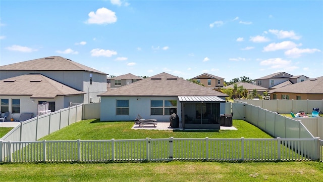 5208 Dandelion St, Apollo Beach, FL 33572 - rear view of house with a sunroom, a fenced backyard, and a yard