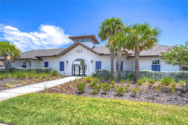 5208 Dandelion St, Apollo Beach, FL 33572 - mediterranean / spanish-style house featuring french doors, stucco siding, and a front yard