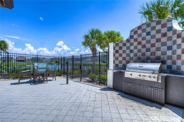 5208 Dandelion St, Apollo Beach, FL 33572 - view of patio with fence, exterior kitchen, and area for grilling