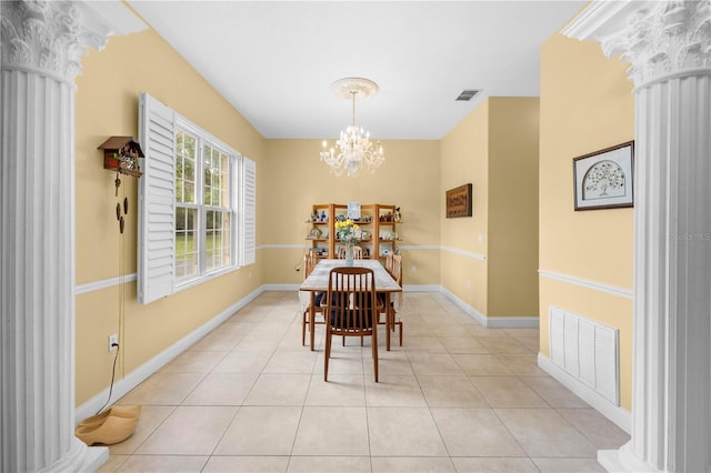 dining area featuring ornate columns, a chandelier, light tile patterned flooring, and baseboards