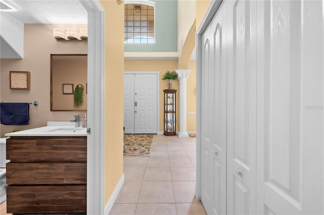 bathroom featuring tile patterned flooring, vanity, and baseboards