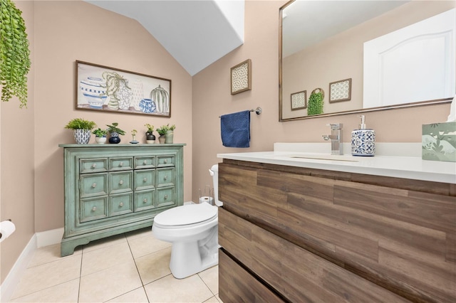 bathroom with vanity, toilet, tile patterned flooring, and vaulted ceiling
