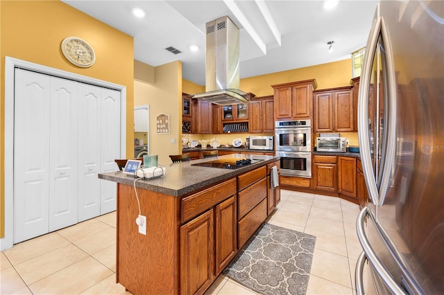 kitchen featuring stainless steel appliances, island exhaust hood, brown cabinets, a center island, and light tile patterned floors