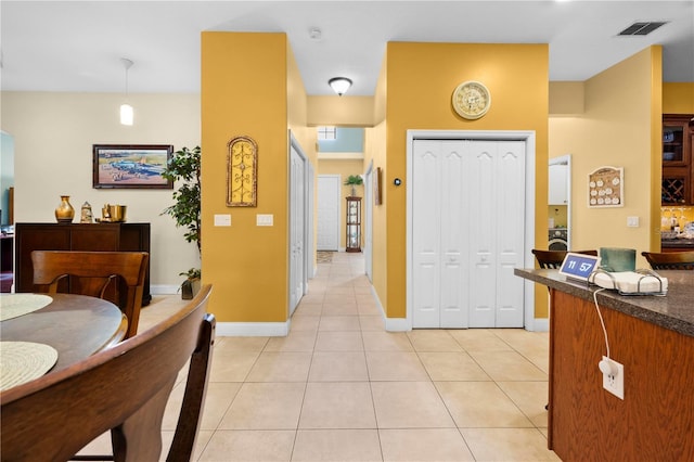 dining space with light tile patterned flooring and baseboards