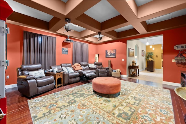 cinema with hardwood / wood-style flooring, coffered ceiling, baseboards, and beam ceiling