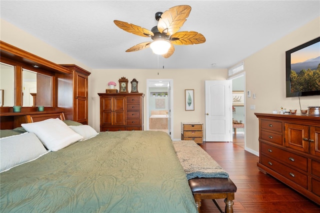 bedroom with dark wood finished floors, ensuite bath, and ceiling fan