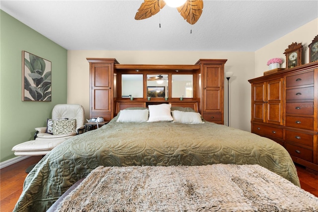 bedroom with wood finished floors, baseboards, and ceiling fan