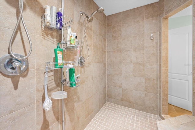 full bath with a tile shower