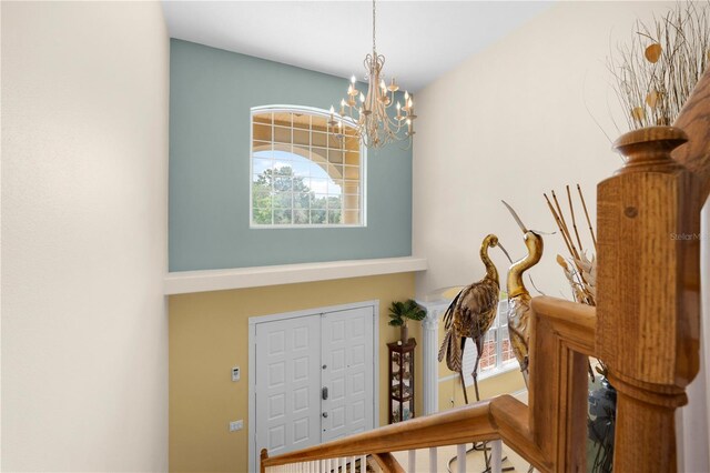 foyer with a chandelier