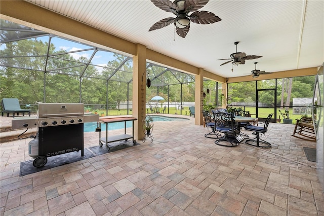 view of patio featuring grilling area, ceiling fan, a lanai, an outdoor pool, and outdoor dining area