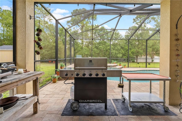 view of patio / terrace featuring glass enclosure and grilling area