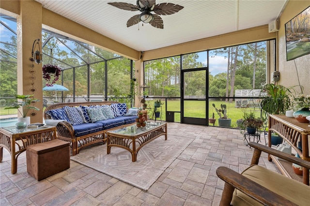 sunroom featuring a ceiling fan and outdoor lounge area