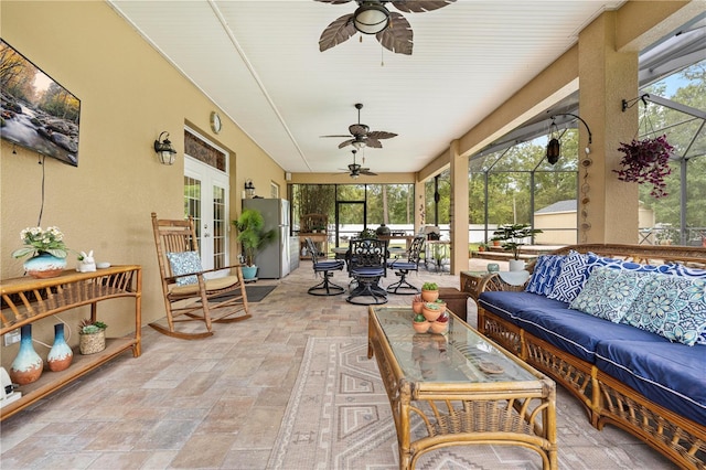 sunroom featuring an outdoor living space, ceiling fan, and outdoor dining space