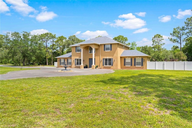 back of property featuring stucco siding and asphalt driveway