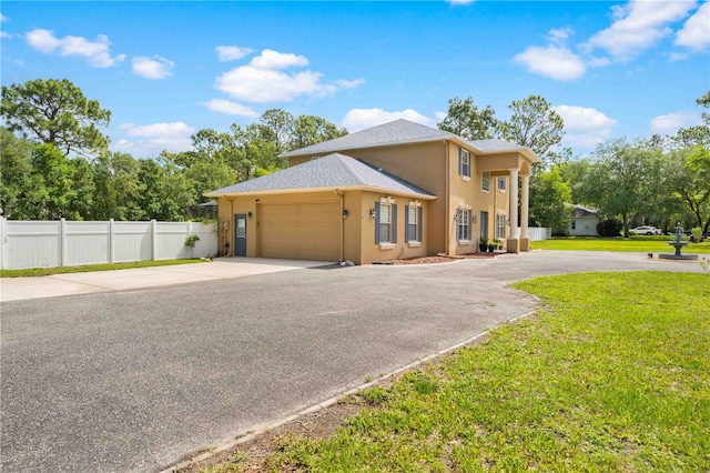 view of front of property with driveway, stucco siding, and a garage