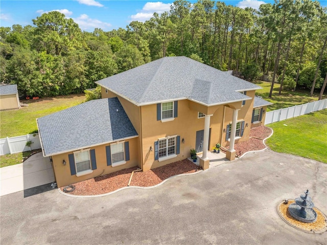 view of front of property with a shingled roof and stucco siding