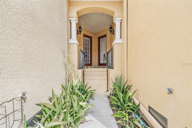 view of exterior entry with stucco siding