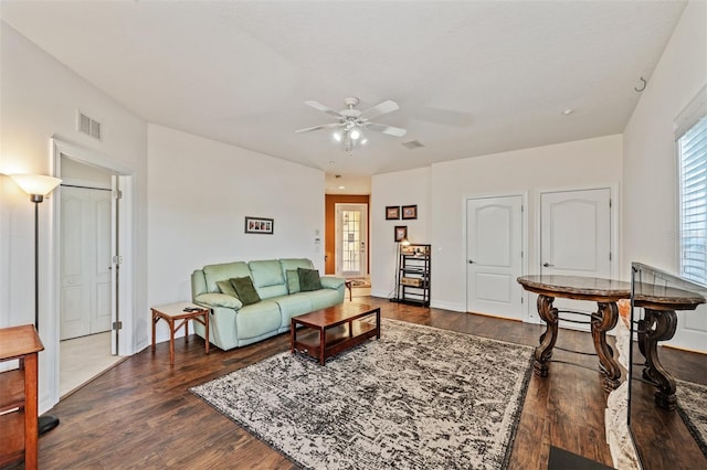 living area with ceiling fan, dark wood-style flooring, and baseboards