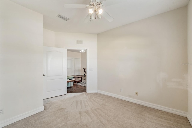 carpeted empty room with baseboards and ceiling fan