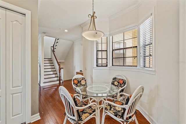 dining room with stairs, hardwood / wood-style flooring, recessed lighting, baseboards, and crown molding