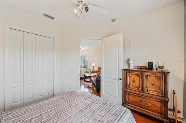 bedroom featuring a closet, wood finished floors, and a ceiling fan