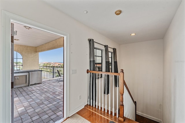 doorway to outside featuring baseboards and recessed lighting