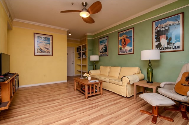 living area with a ceiling fan, ornamental molding, wood finished floors, and baseboards