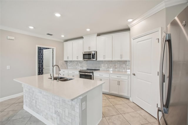 kitchen with light tile patterned flooring, appliances with stainless steel finishes, a sink, and tasteful backsplash