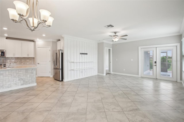 unfurnished living room featuring visible vents, crown molding, ceiling fan with notable chandelier, and light tile patterned flooring