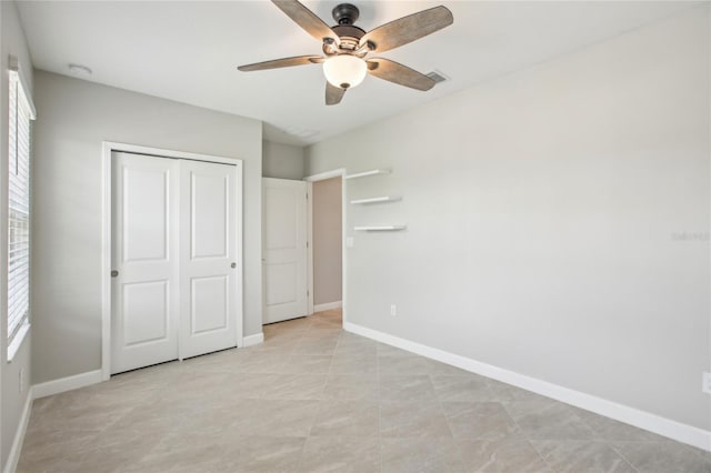 unfurnished bedroom featuring baseboards, ceiling fan, a closet, and visible vents