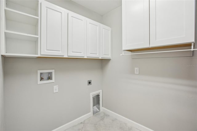 clothes washing area with cabinet space, electric dryer hookup, baseboards, and washer hookup