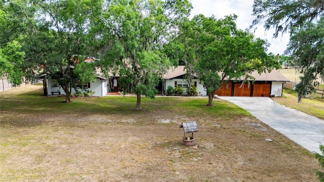 36601 Roberts Rd, Dade City, FL 33525 - obstructed view of property featuring concrete driveway and a front yard