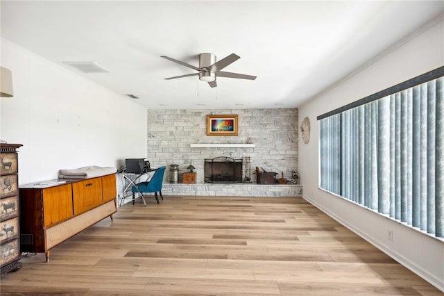 36601 Roberts Rd, Dade City, FL 33525 - living area featuring ceiling fan, a stone fireplace, light wood-style flooring, visible vents, and ornamental molding