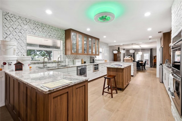 36601 Roberts Rd, Dade City, FL 33525 - kitchen with a peninsula, a kitchen island, recessed lighting, a sink, and stainless steel appliances
