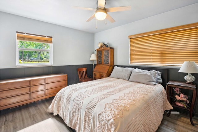 36601 Roberts Rd, Dade City, FL 33525 - bedroom with a ceiling fan, wood finished floors, and a wainscoted wall