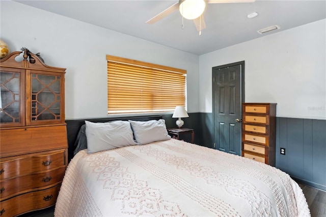 36601 Roberts Rd, Dade City, FL 33525 - bedroom featuring a ceiling fan, visible vents, wainscoting, and wood finished floors