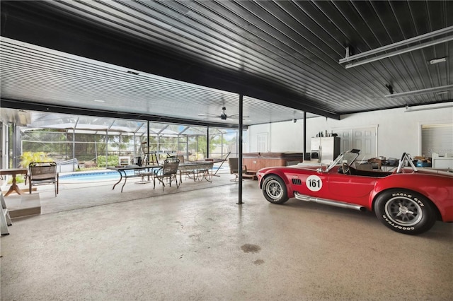 36601 Roberts Rd, Dade City, FL 33525 - garage with stainless steel refrigerator with ice dispenser, a ceiling fan, and an outdoor pool